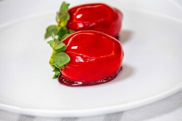 The iconic and delicious Brazilian strawberry of love, prepared with fresh strawberries, white brigadeiro and crunchy caramel on the surface. Morango do amor