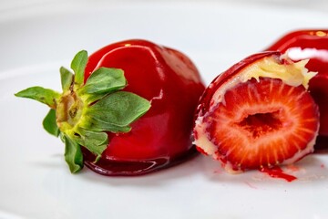 The iconic and delicious Brazilian strawberry of love, prepared with fresh strawberries, white brigadeiro and crunchy caramel on the surface. Morango do amor