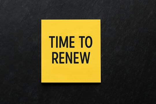 Time to renew text message on yellow sticky note over black textured background, reminder for subscription renewal, contract extension, service update, membership continuation, business deadline alert