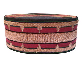 Traditional Lampung  cap made from  tapis fabric
with isolated white background, representing...