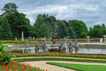 Stone fountain with  statues in Waddesdon Manor park