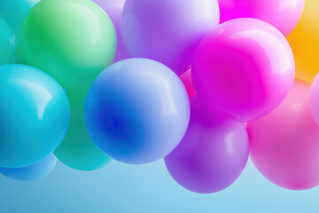 Colorful balloons in various shades floating against a soft blue background with vibrant hues