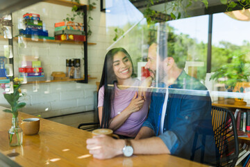 Happy couple enjoying coffee and conversation in cozy cafe