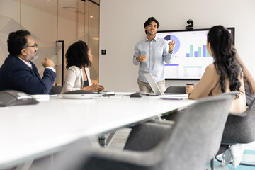 Business development briefing. Young man ceo boss stand by table in conference room lead strategy...
