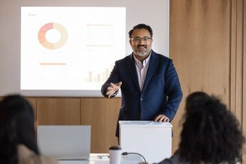 Business strategy session. Inspired smiling mid aged businessman corporate leader speaking from...