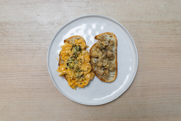 Bread toast with scrambled eggs and mushroom.