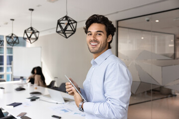 Success in corporate career growth. Office portrait smiling confident young male white collar...