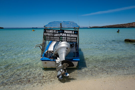 Pichilingue Beach, La Paz, MX - April  2025: Back view of a typical tour motorboat (known locally as pangas) that take visitors to nearby Isla Esp&iacute;rito Santo and Playa Balandra.