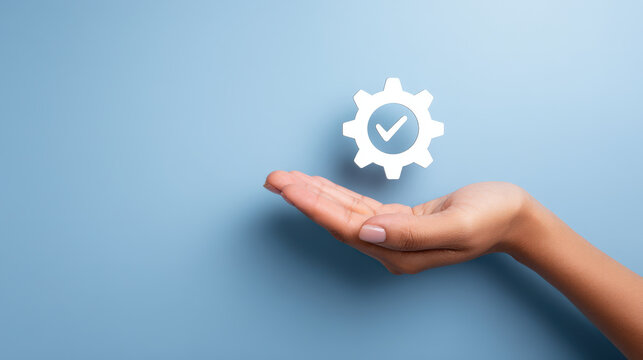 Hand gently supports gear icon with checkmark symbolizing trusted repair services in shop setting