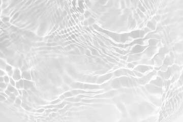 Fototapeta premium White water with ripples on the surface. Defocus blurred transparent white colored clear calm water surface texture with splashes and bubbles. Water waves with shining pattern texture background.