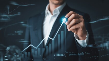 Businessman drawing an upward trending financial graph on a digital screen