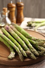 Fresh raw asparagus on wooden table, closeup