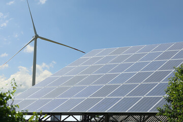 Solar panels and wind turbine outdoors. Alternative energy source