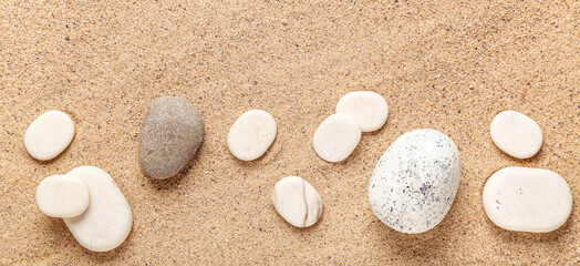 Different pebbles on beach sand