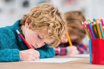 Pupils focusing intently on their artwork during an engaging art class in a vibrant, well lit classroom filled with creativity