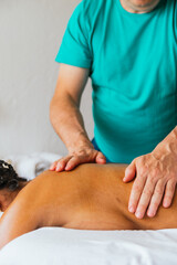 A man massages a woman's back