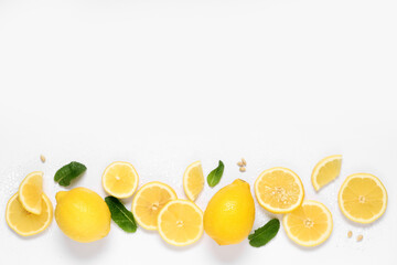 Fresh ripe lemons and leaves on grey background