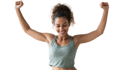 A joyful woman celebrating her fitness success with arms raised in victory against a white isolated background.