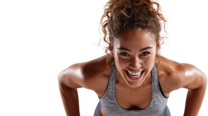 Athletic woman exercising with determination, showing strength and motivation in a dynamic fitness environment.