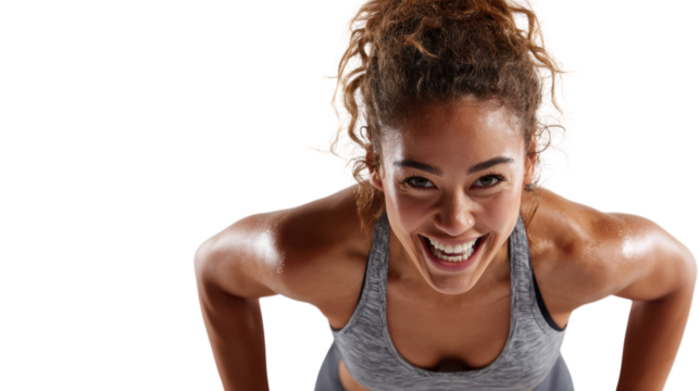 Athletic woman exercising with determination, showing strength and motivation in a dynamic fitness environment.