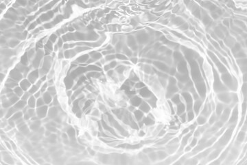 White water with ripples on the surface. Defocus blurred transparent white colored clear calm water surface texture with splashes and bubbles. Water waves with shining pattern texture background.