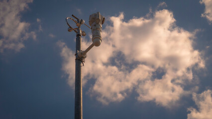 weather catcher; weather instrument in front of cloudy sky