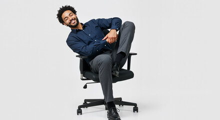 A Happy And Relaxed Young Man Sitting Casually In An Office Chair With His Legs Crossed