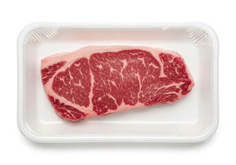 Obraz premium Raw beef steak in white styrofoam tray close up