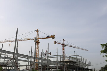 New construction site with crane and mechanical equipments on sky background.
