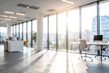 Obraz premium Bright Modern Office Space with Large Windows and Blurred Workstations in Daylight