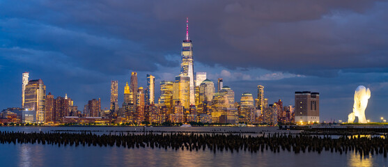New York city. NYC cityscape. Lower Manhattan and One World Trade Center in New York Cit. Skyscrapers of Manhattan located near rippling water of New York bay against blue sky. New York skyscrapers.