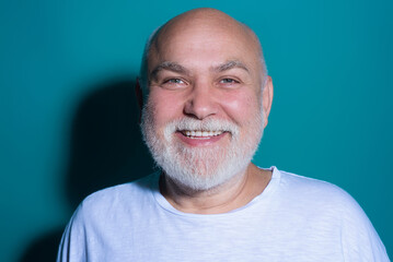 Obraz premium Portrait of Grandfather. Senior face with grey beard isolated. Close-up headshot of elderly Grandfather. Casual retired man. Grandfather 60s man studio portrait. Grandfather with grey beard.