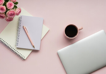 Feminine workspace with laptop notebook coffee and flowers