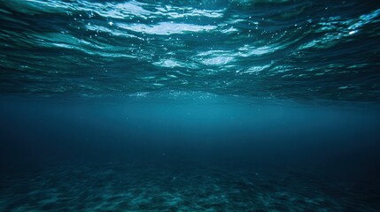 Dark Blue Ocean Surface Seen from Underwater &ndash; Sunbeams Piercing Deep Waters, Waves Rippling Above in Indigo Hues