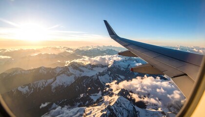 Aerial view of mountains from airplane window at sunset