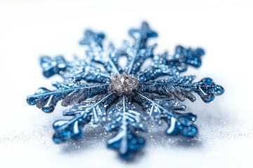Fototapeta premium Sparkling blue snowflake with glittery details on white.