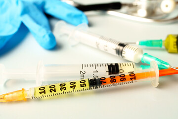 Naklejka premium Medical equipment including syringes, stethoscope and gloves laying on table, ready for use