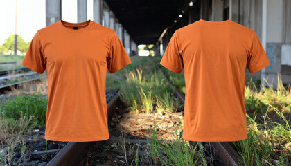 Burnt orange t-shirt displayed front and back, on overgrown railway tracks.
