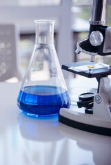 Vertical Horizon Science laboratory chemistry test science lab with microscope glass tubes on white table scientific background. Vertical Colorful Liquid biology scientist laboratory chemical fluid