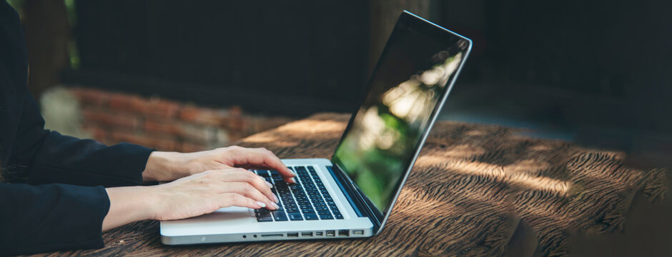 Banner Asian Woman using laptop working from home online meeting in home office. Banner Happy relax time asian business woman typing keyboard notebook laptop Smiling at home office with copy space