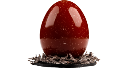 Delicious red chocolate egg set on chocolate shavings