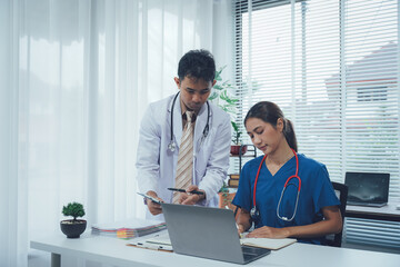 Medical Professionals Collaborate: Focused moment of two medical professionals, engrossed in a...