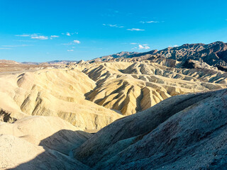 Wide-angle horizontal view of Mesquite Flat Sand Dunes showcasing golden and brown sand formations...