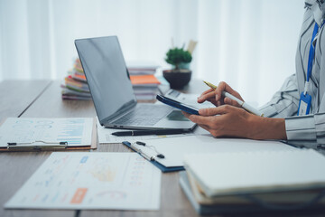 Two business people talk project strategy at office meeting room. Businessman discuss project planning with colleague at modern workplace while having conversation and advice on financial data report.