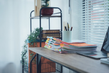 Modern Workspace Still-Life: A well-lit workspace showcasing organized files, stationary, and a touch of greenery, reflecting the aesthetics of a modern office.