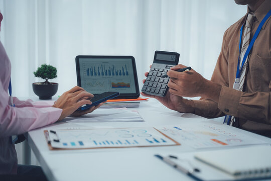 Businessman team working at office with document on his desk, doing planning analyzing the financial report, business plan investment, finance analysis concept. Economic business discussions.
