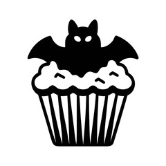 A spooky bat sits atop a frosted cupcake isolated on white background