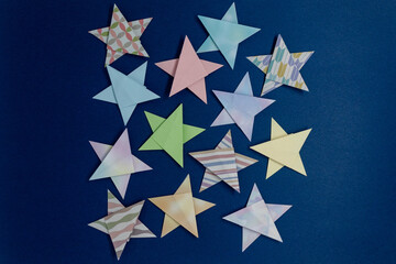 Origami is a traditional Japanese paper craft in which colored paper is folded into shapes such as flowers. This is a piece folded into a star.