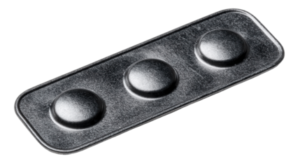 Metallic Tablet: An up-close view captures a metallic tablet, its surface etched with three raised, rounded bumps and a sense of industrial style.