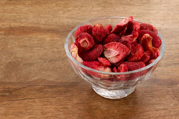 Freeze-dried strawberry. Strawberries in Glass Bowl on wooden table